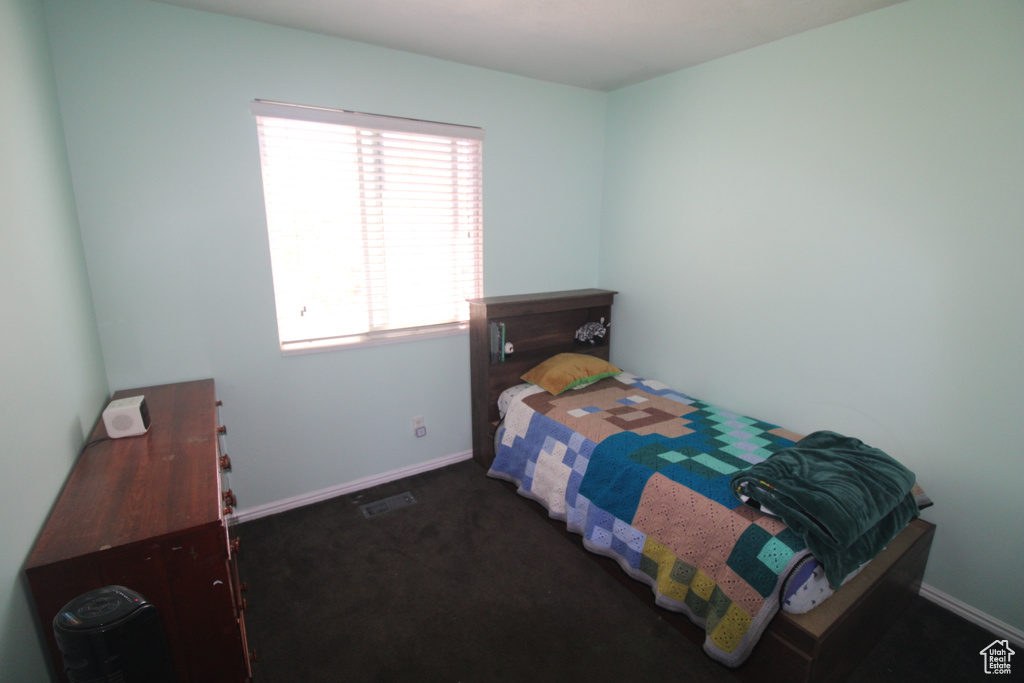 Carpeted bedroom featuring baseboards