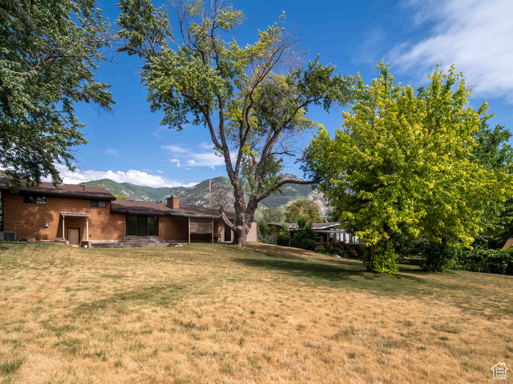 View of grassy yard with a mountain view