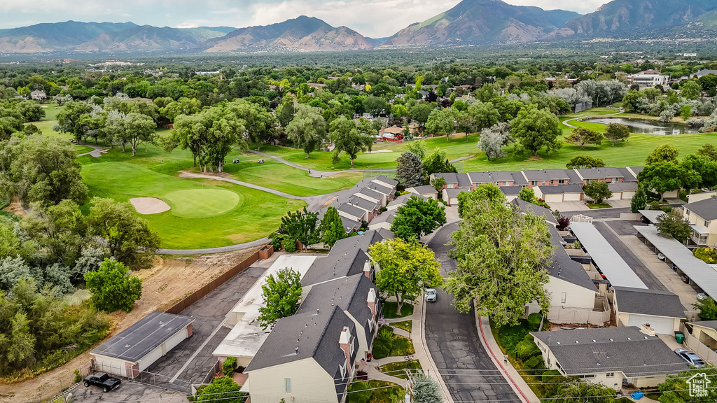 Aerial perspective of suburban area featuring a water and mountain view and a local golf course
