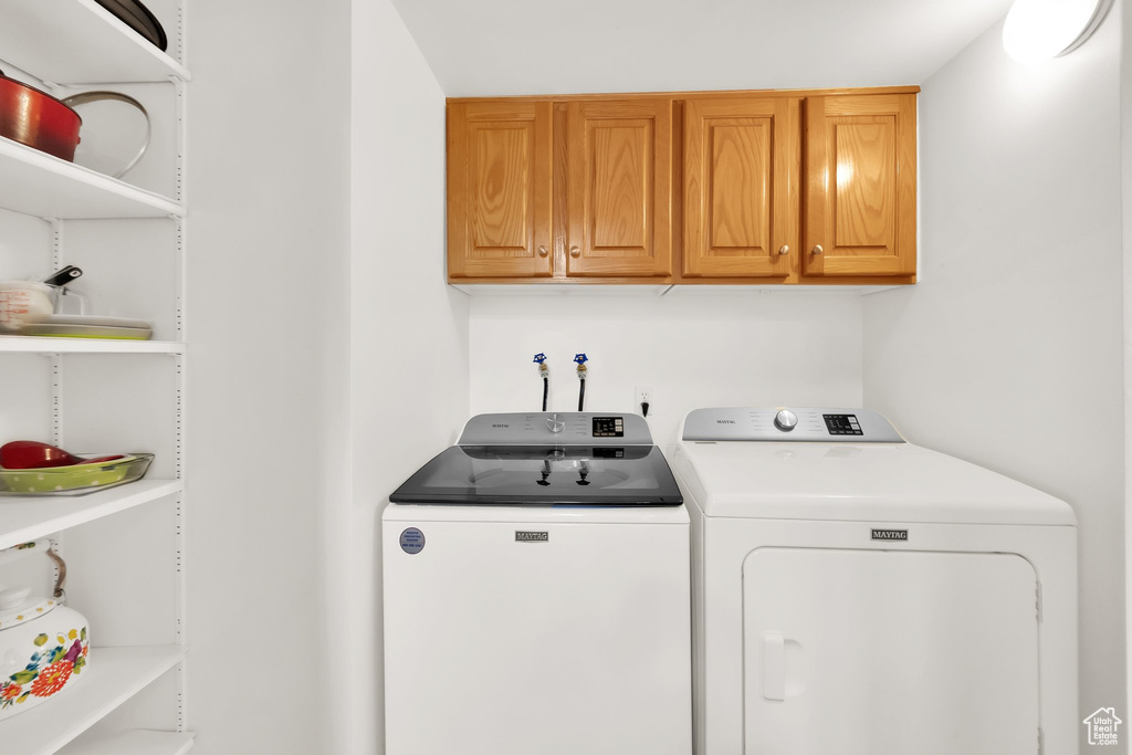 Laundry area featuring washer and dryer and cabinet space