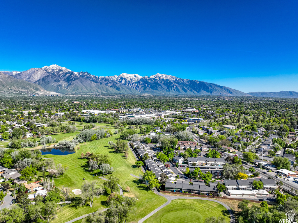 Aerial perspective of suburban area with a water and mountain view and a golf course