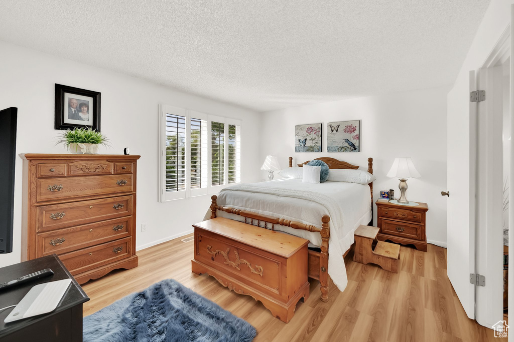 Bedroom featuring a textured ceiling and light wood-style flooring