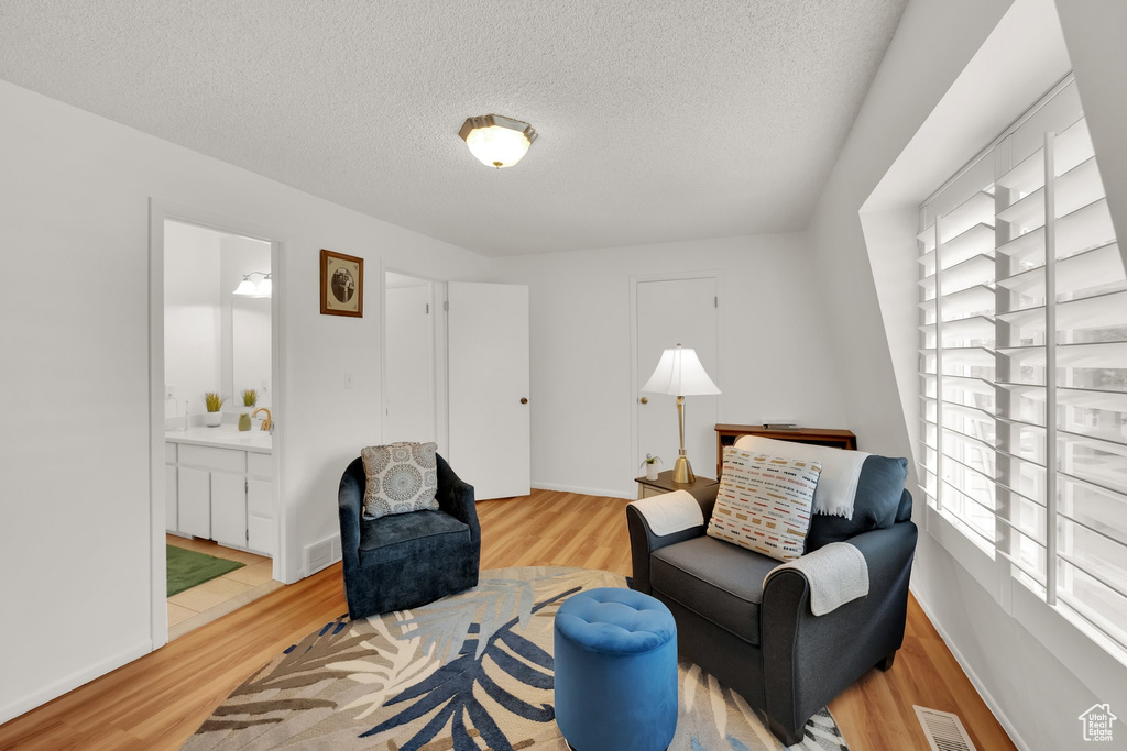 Sitting room featuring wood finished floors and a textured ceiling