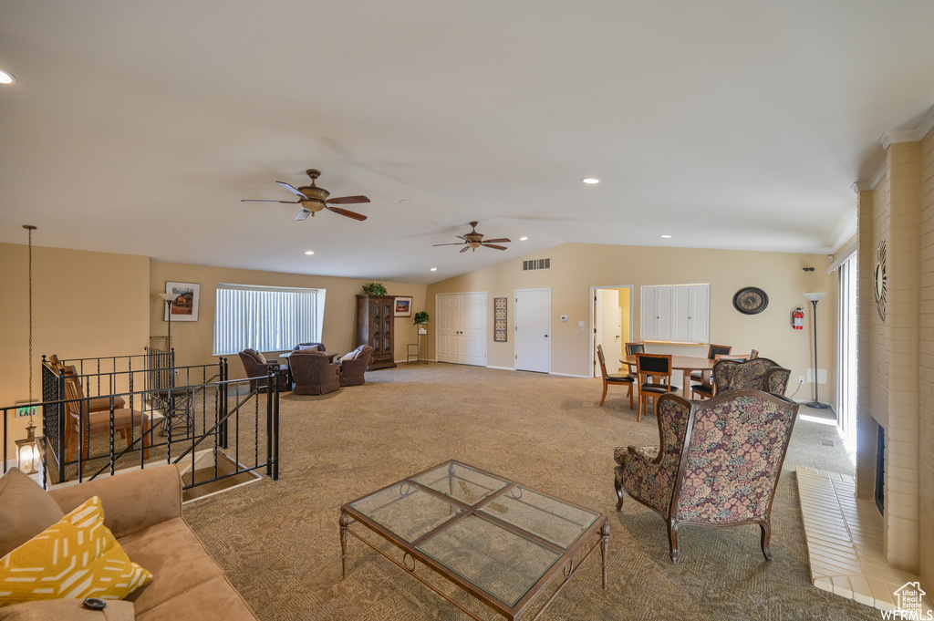 Living area featuring carpet flooring, a ceiling fan, vaulted ceiling, healthy amount of natural light, and recessed lighting