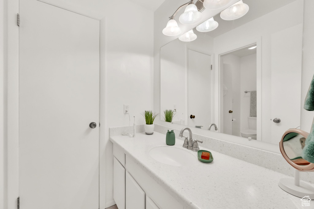 Bathroom featuring vanity and toilet