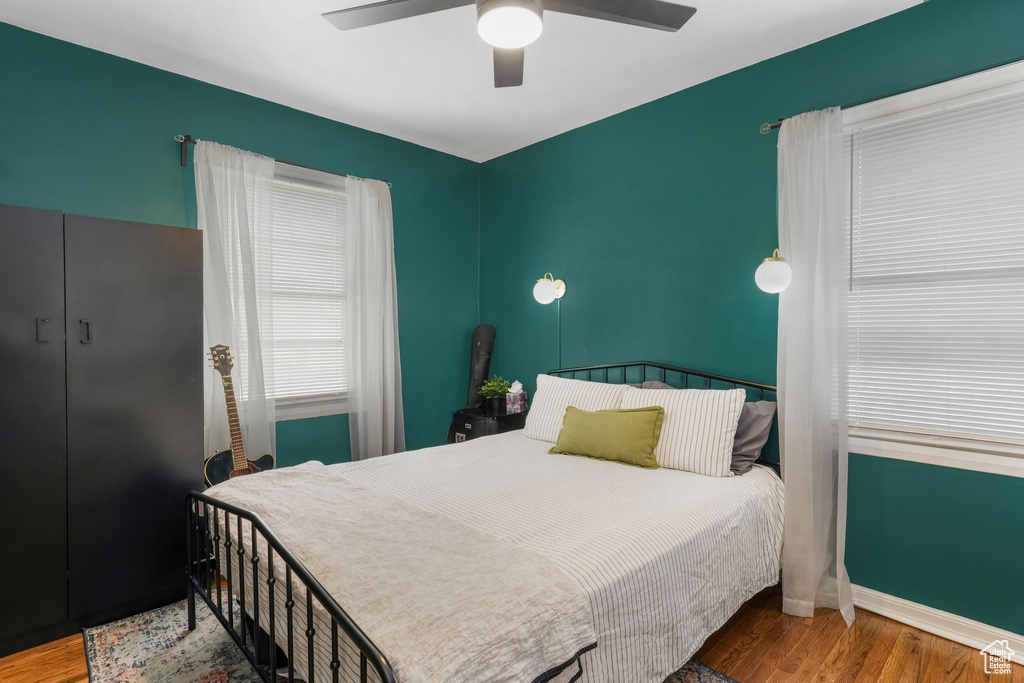 Bedroom with wood finished floors and a ceiling fan