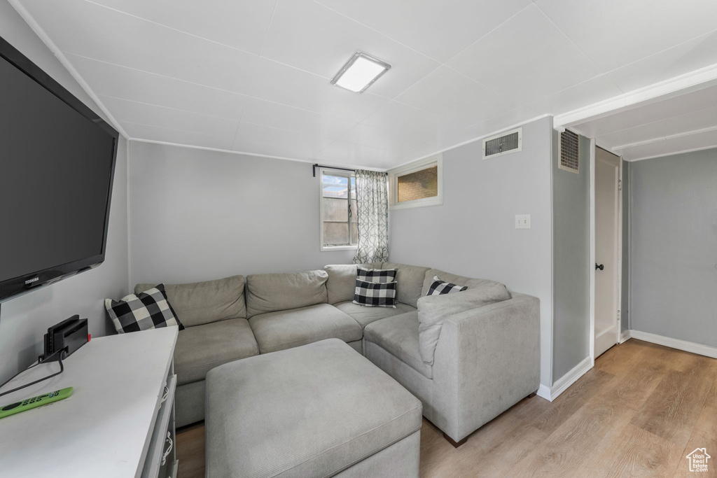 Living room with light wood-style flooring and baseboards