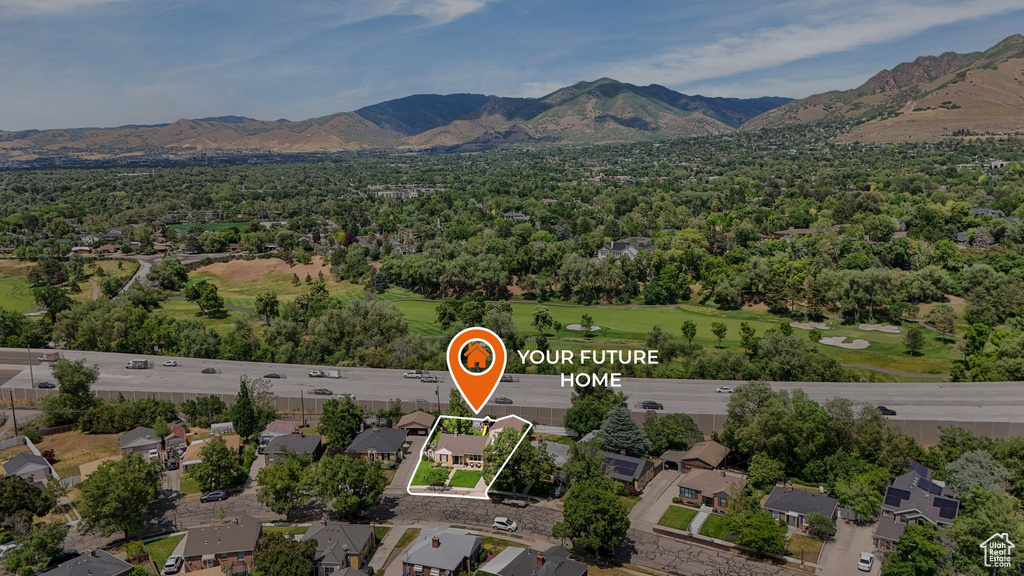 Aerial view of residential area featuring mountains and property boundaries highlighted