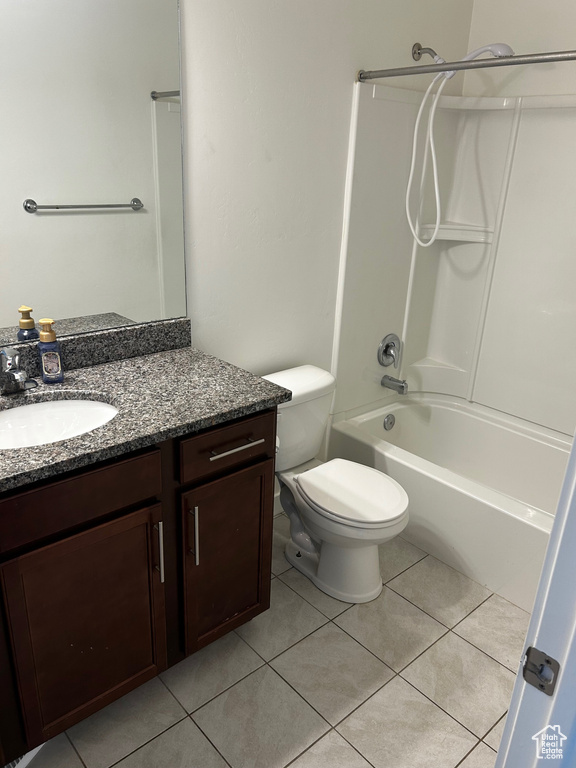 Bathroom featuring vanity, shower / washtub combination, and tile patterned flooring