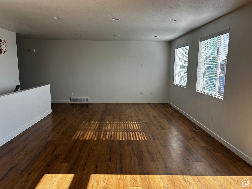 Empty room with wood finished floors and recessed lighting