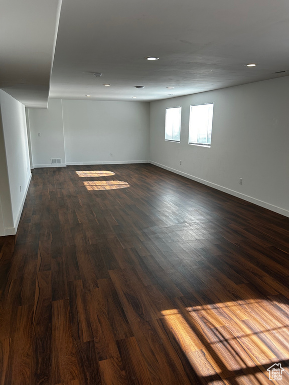 Spare room with dark wood finished floors and baseboards