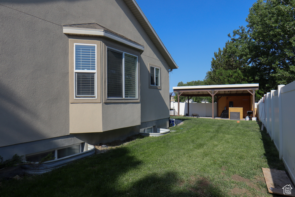 View of property exterior with a fenced backyard and stucco siding