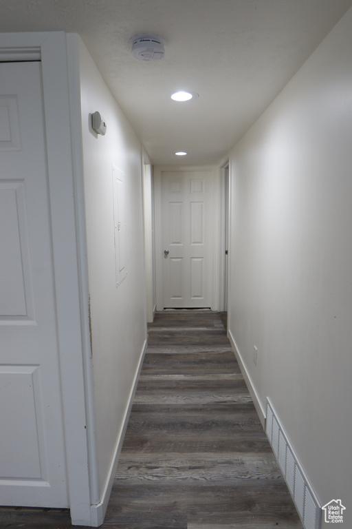 Hallway featuring dark wood-style flooring and recessed lighting