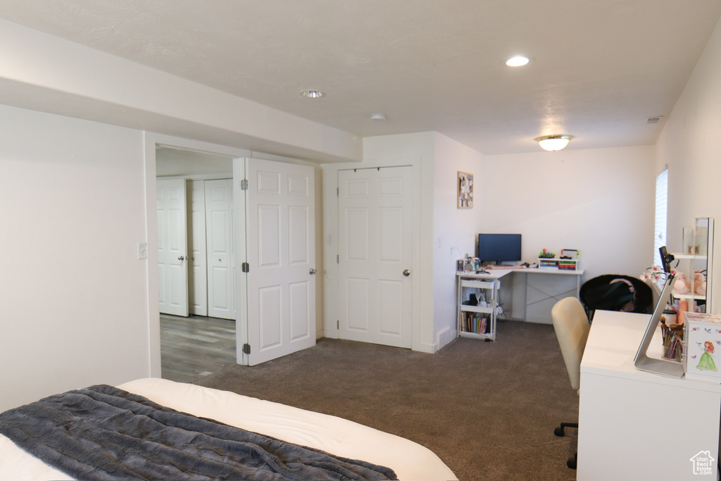 Carpeted bedroom featuring an office area and recessed lighting