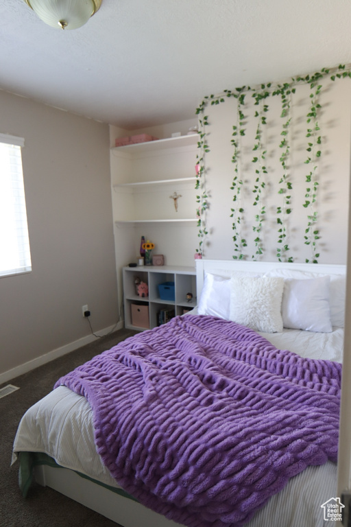 Bedroom featuring carpet floors and baseboards