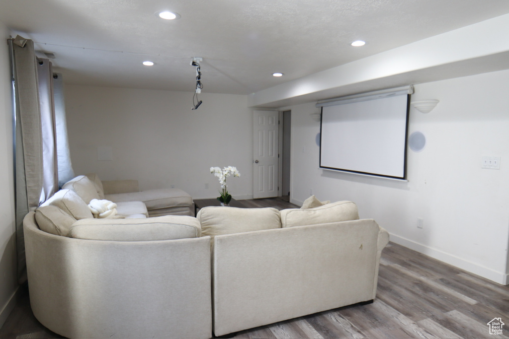 Home theater room with wood finished floors and recessed lighting