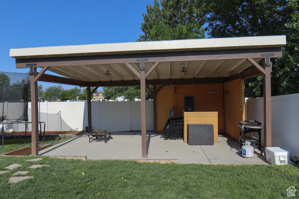 View of patio featuring a gazebo and a trampoline