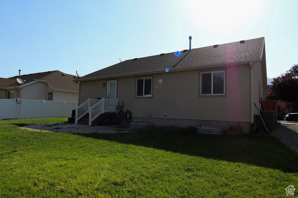 Rear view of house featuring stucco siding