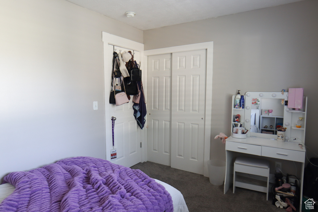 Bedroom featuring carpet and a closet