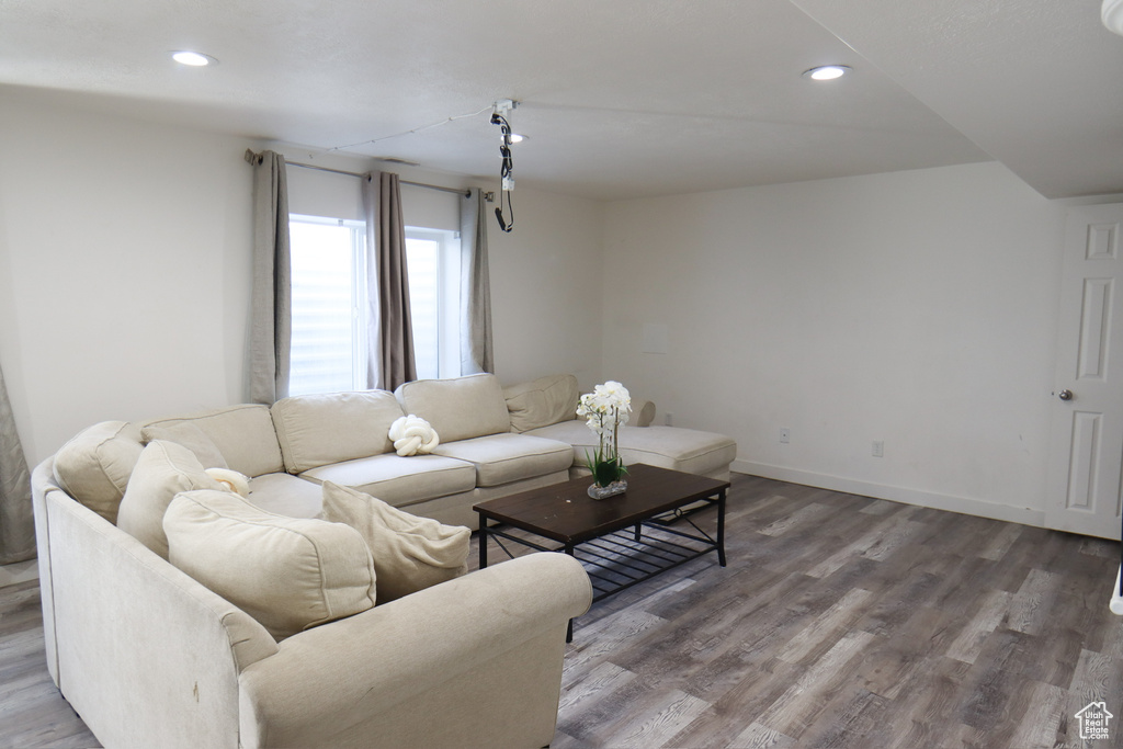 Living area featuring wood finished floors and recessed lighting