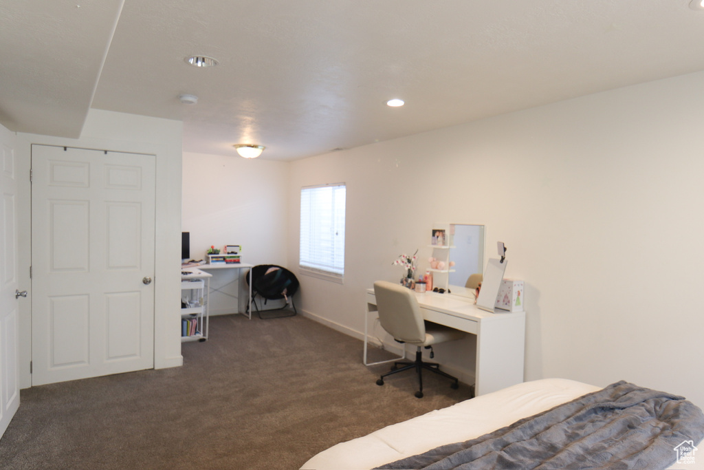 Carpeted bedroom featuring an office area and recessed lighting
