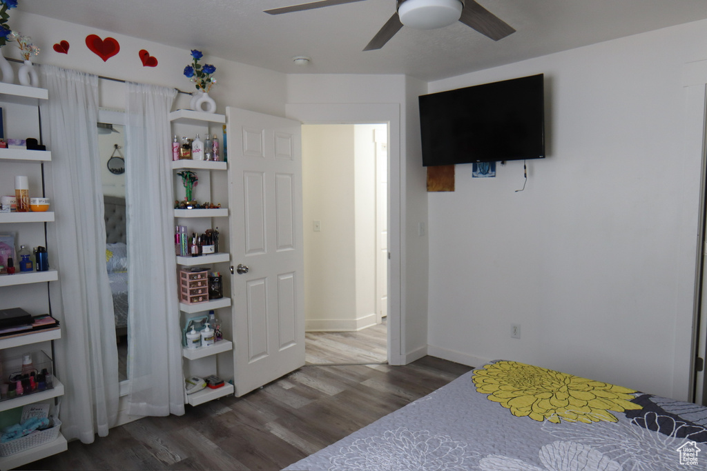 Bedroom with wood finished floors and a ceiling fan