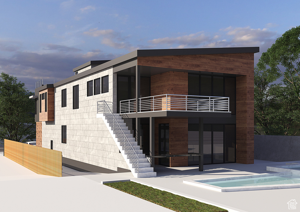 Modern home featuring a balcony, stairway, an outdoor pool, and a patio area