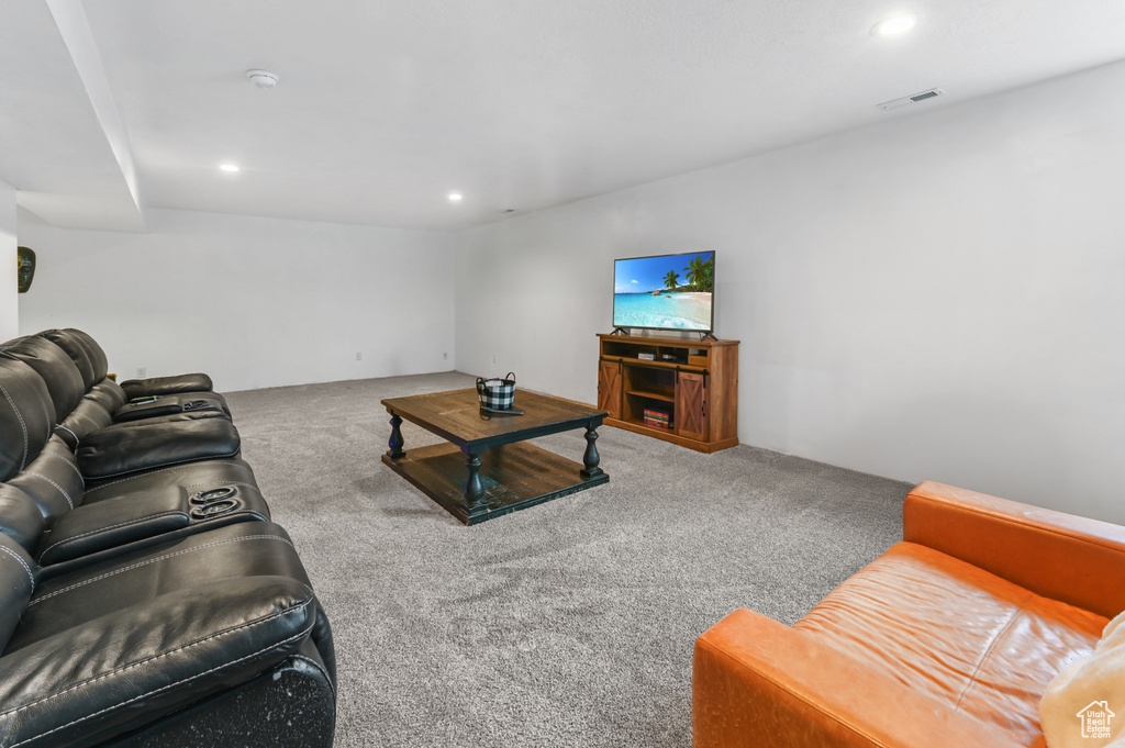 Carpeted living area with recessed lighting