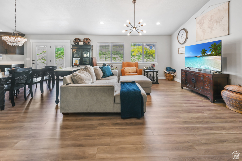 Living room featuring a chandelier, wood finished floors, and recessed lighting