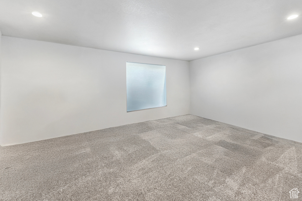 Carpeted spare room featuring recessed lighting