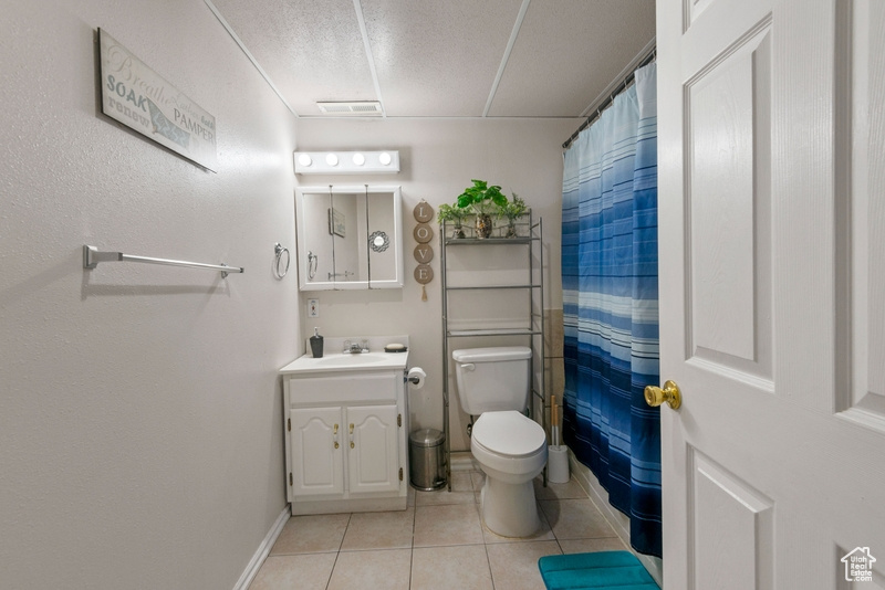 Bathroom with vanity, tile patterned flooring, and a shower with curtain