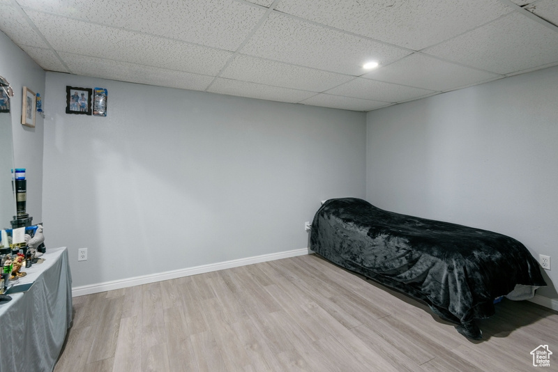 Bedroom featuring light wood-style floors and a paneled ceiling