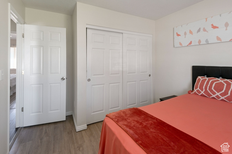 Bedroom featuring light wood-type flooring and a closet