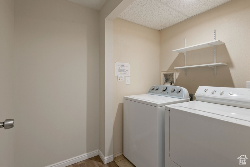 Washroom featuring separate washer and dryer and baseboards