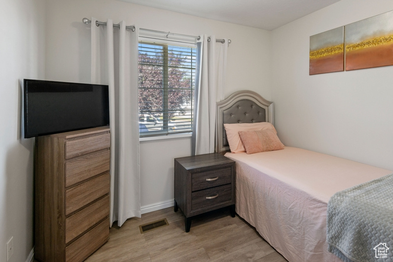 Bedroom featuring light wood-style flooring and baseboards