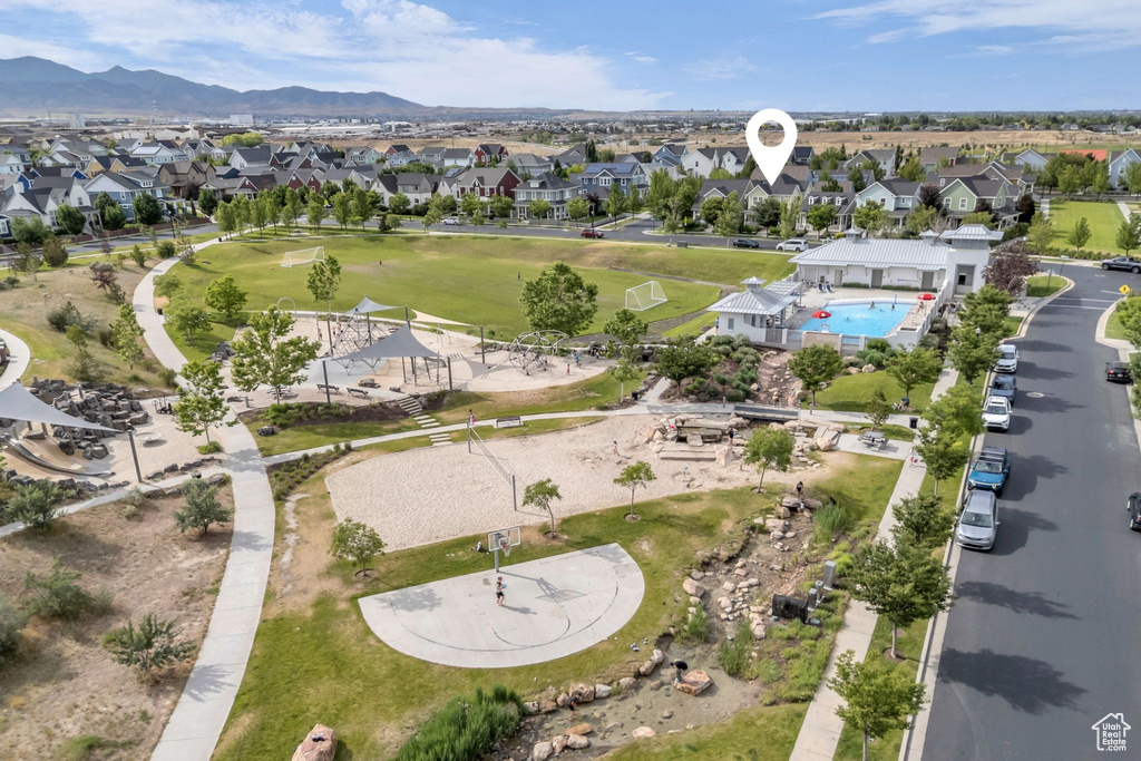 Aerial view of property and surrounding area with nearby suburban area and a mountainous background