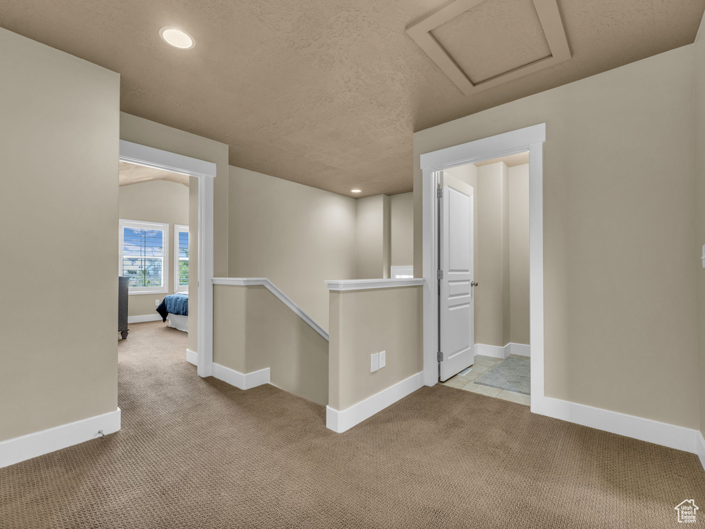 Hallway featuring carpet flooring, an upstairs landing, attic access, and recessed lighting