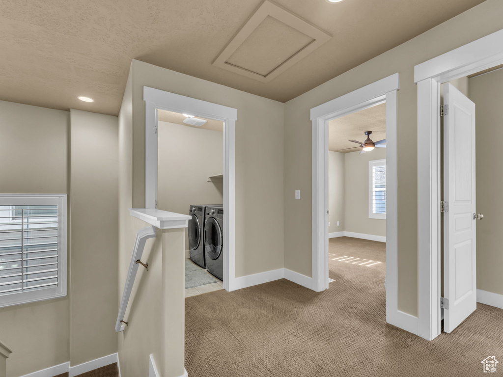 Corridor with washing machine and clothes dryer, carpet floors, and recessed lighting