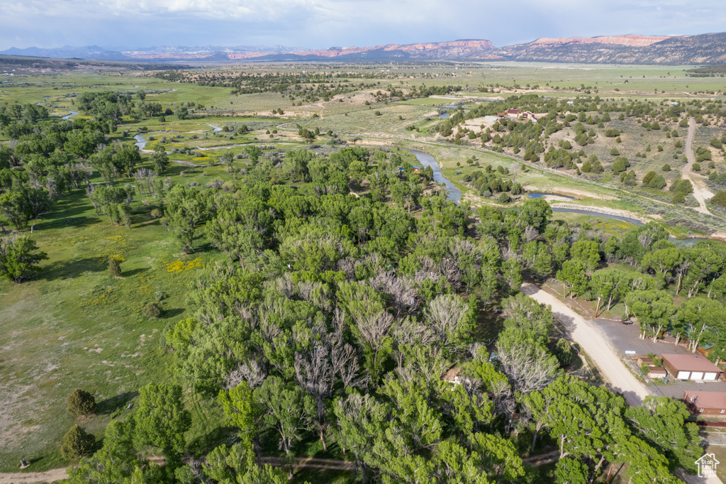 Aerial view of property and surrounding area with a mountainous background