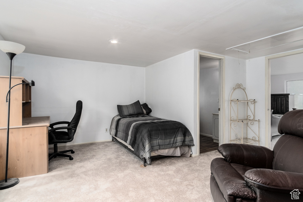 Bedroom featuring attic access and light carpet