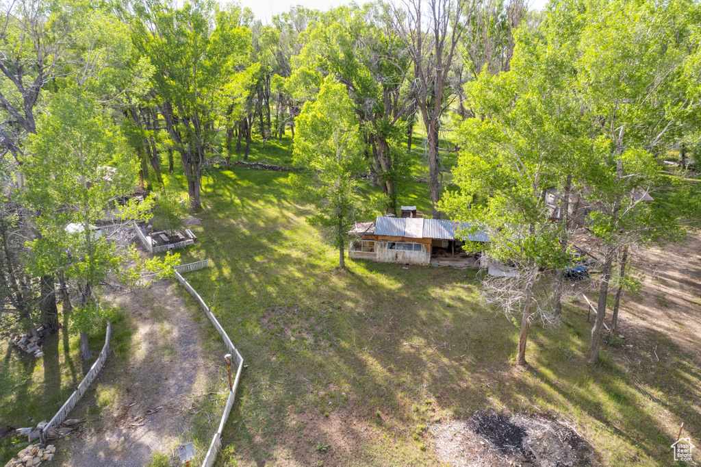 Aerial view of property and surrounding area with a forest