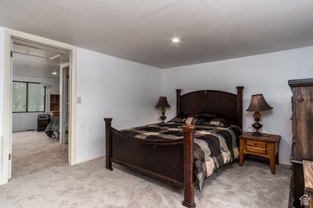 Bedroom featuring light colored carpet, attic access, and recessed lighting
