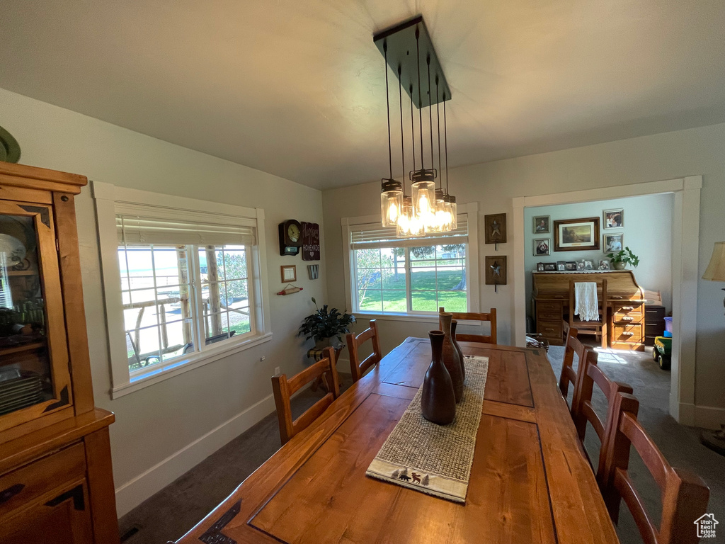 Dining space with a chandelier and baseboards