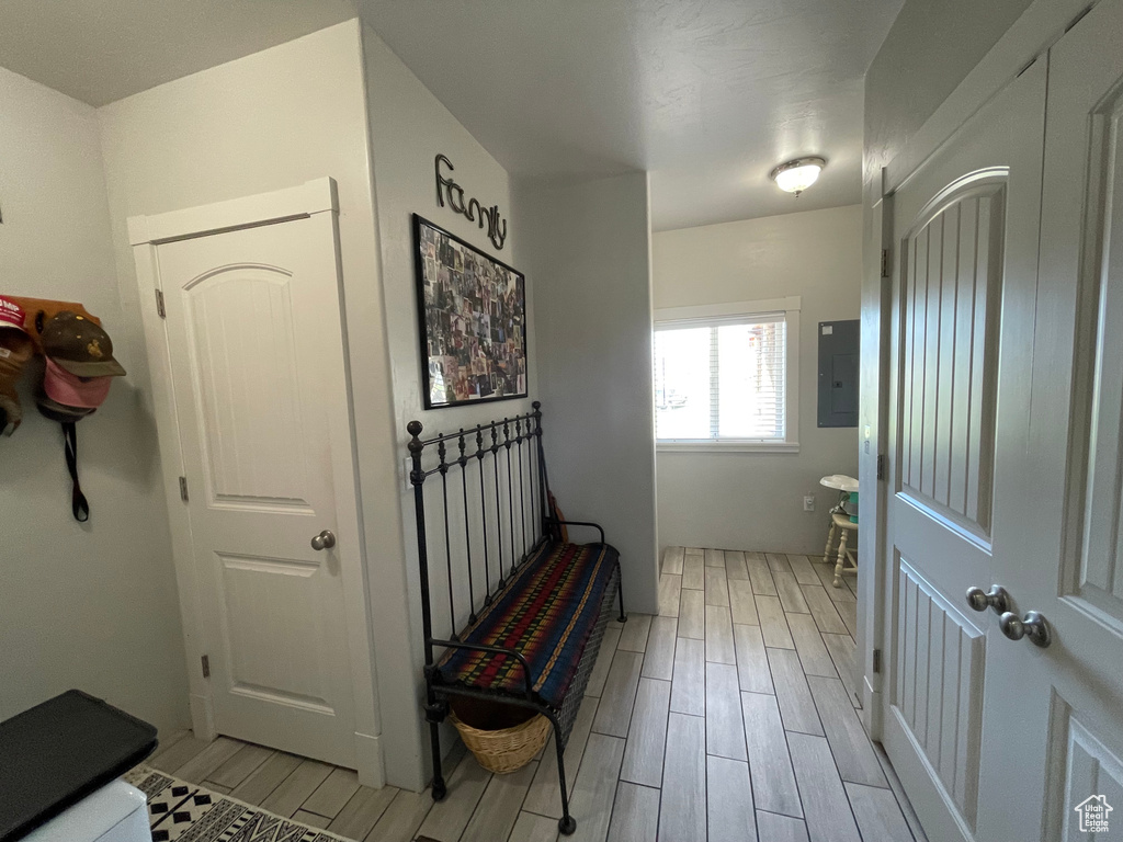 Hallway featuring wood tiled floors and electric panel