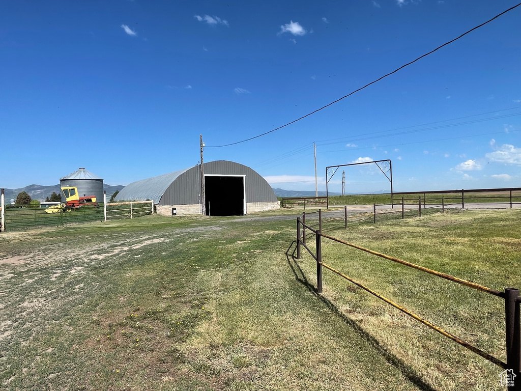 View of yard featuring an outbuilding, a detached garage, and a view of rural / pastoral area