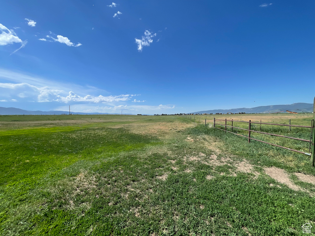 View of yard with a rural view and a mountain view
