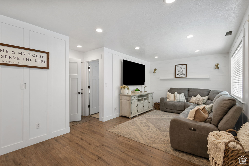 Living room featuring wood finished floors and recessed lighting