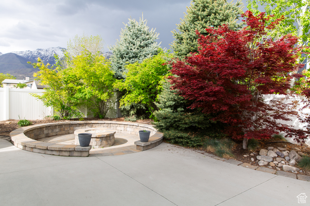 View of patio featuring an outdoor fire pit and a mountain view