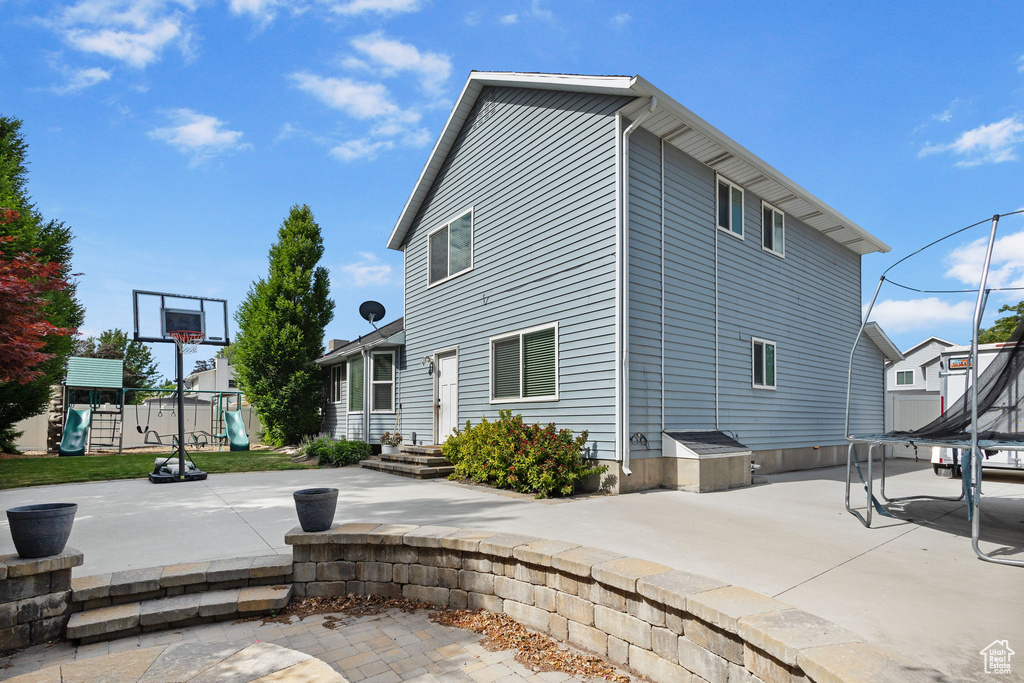 View of home's exterior featuring a playground and a patio