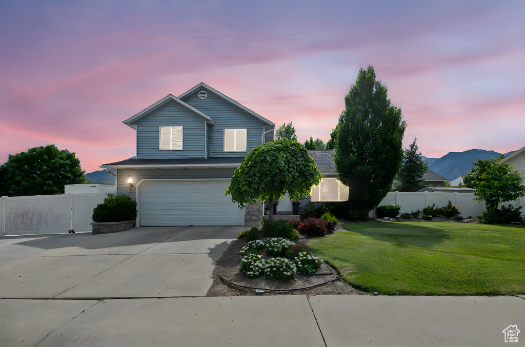 View of front of property with an attached garage and driveway